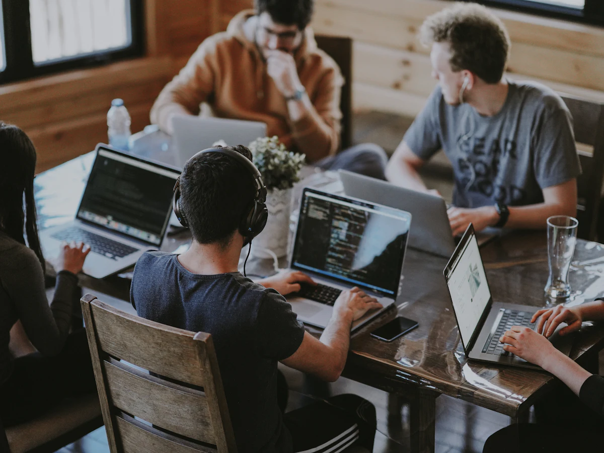 A media team planning a campaign together on laptops